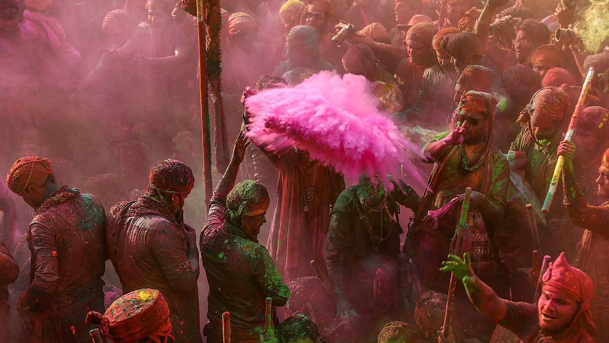 People apply colours on each other during the Lathmar Holi celebrations at Nandgaon, in Mathura.