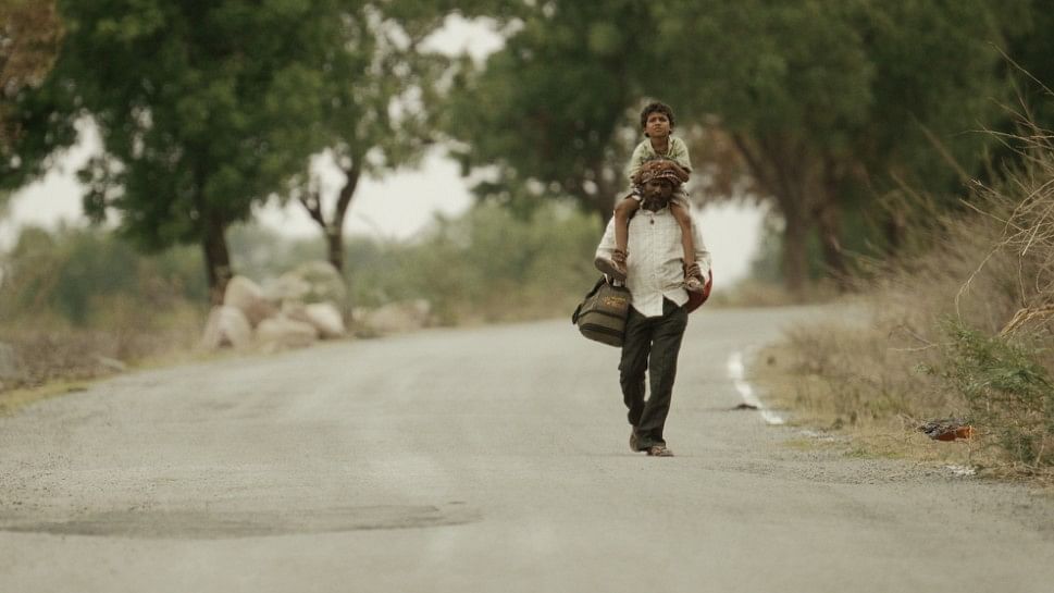 Durgya (Veeresh Gonwar) and his father (Mahadev Hadpad) walk back home in a still from the film. 
