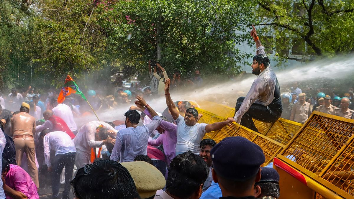 Security personnel use water cannon to disperse BJP workers during their protest demanding the resignation of Delhi Chief Minister Arvind Kejriwal after his arrest by the ED.