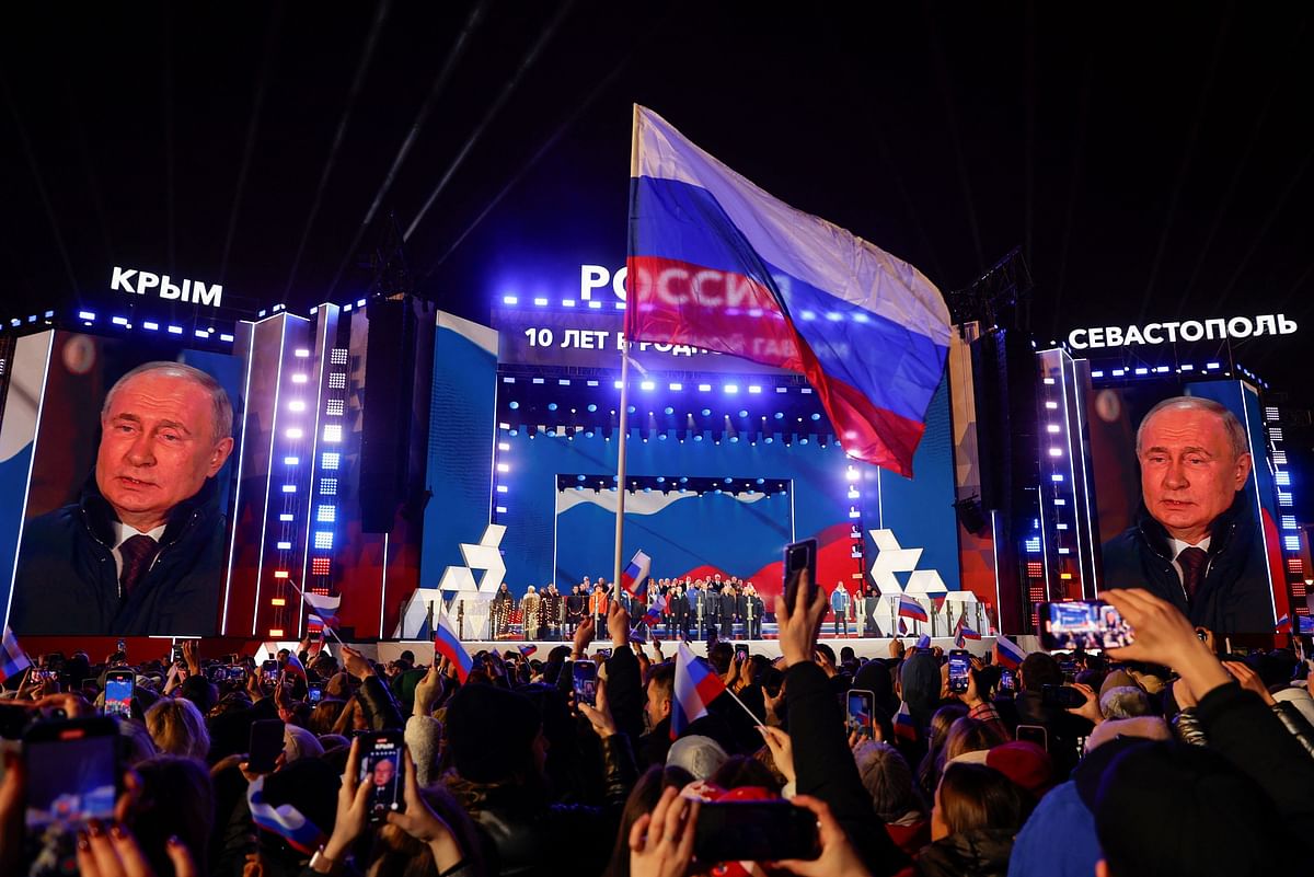 Russian incumbent President Vladimir Putin, who was declared winner of the presidential election by the country's electoral commission, is seen on screens on the stage as he attends a rally, which marks the 10th anniversary of Russia's annexation of Crimea from Ukraine, in Red Square in central Moscow, Russia, March 18, 2024. 