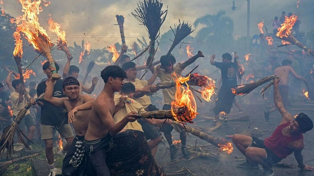 Worshipers take part during the 'Perang Api', a war of fire tradition that is believed for cleansing the evil elements and keeping away from misfortune, ahead of Nyepi Day, a day of silence for self-reflection marking the Balinese Hindu new year in Mataram, Lombok island, Indonesia, March 10, 2024.