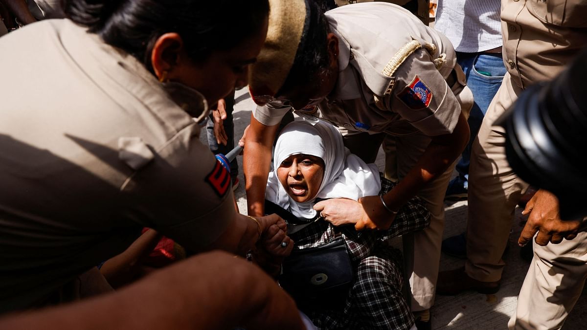 A supporter shouts as Delhi Police detain her for staging a protest in Delhi.