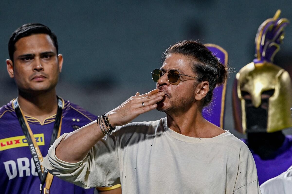 Bollywood actor and owner of the IPL team Kolkata Knight Riders Shah Rukh Khan greets his supporters after the end of the IPL tie in Kolkata.