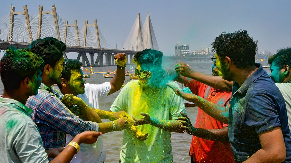 Youngsters play with colours during Holi festival celebrations, in Mumbai.