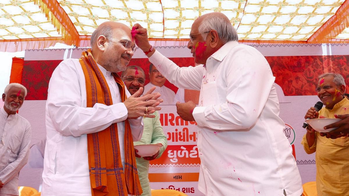 Gujarat Chief Minister Bhupendra Patel applies colour on Home Minister Amit Shah during the 'Dhuleti Mahotsav' celebrations in Gujarat.