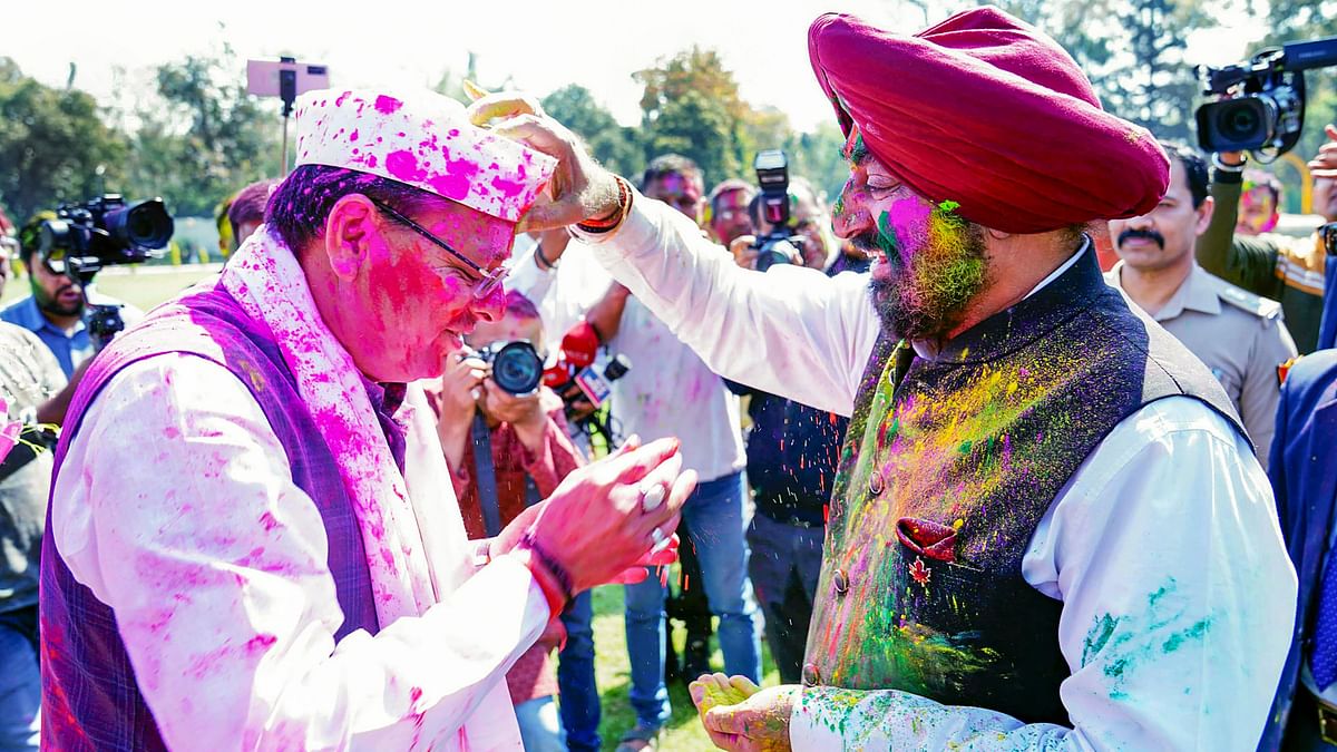 Uttrakhand Governor Lieutenant General Gurmit Singh applies colour on Uttrakhand Chief Minister Pushkar Singh Dhami during Holi celebrations in Dehradun.