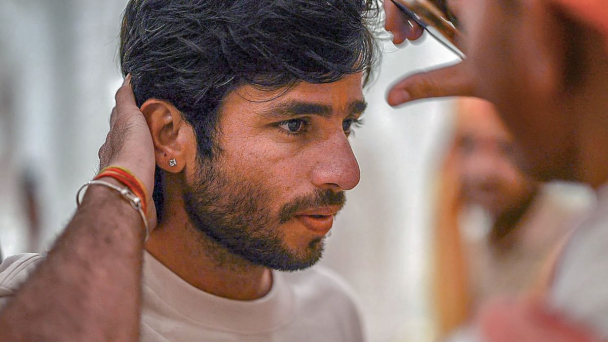 Ravi Bishnoi gets the tilak applied on his forehead during his visit to the Ram temple ahead of IPL 2024 tournament, in Ayodhya