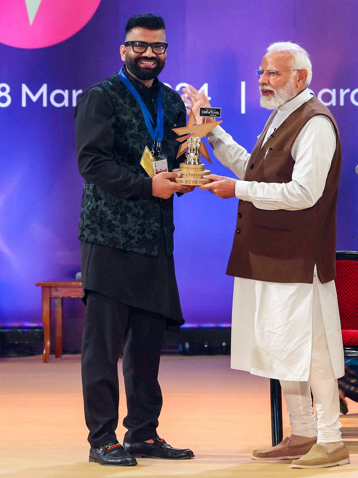 Gaurav Chaudhary aka “Technical Guruji” accepts the "Best Tech Creator" award from Prime Minister Narendra Modi at the National Creators Award 2024 in New Delhi.