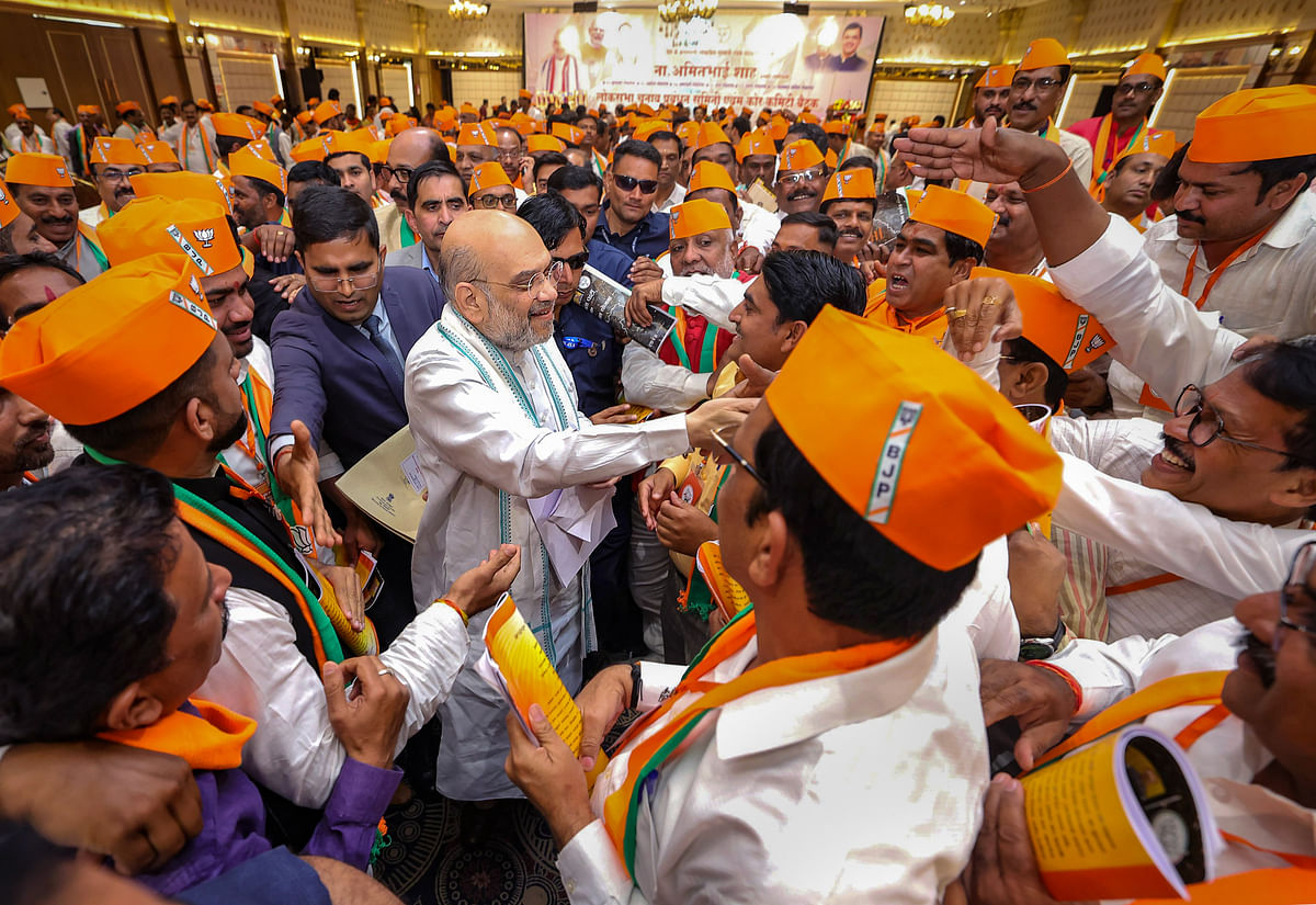 Union Home Minister Amit Shah being greeted by BJP workers during the BJP Lok Sabha Election Management Committee and Lok Sabha Core Committee meeting, in Akola, on Tuesday