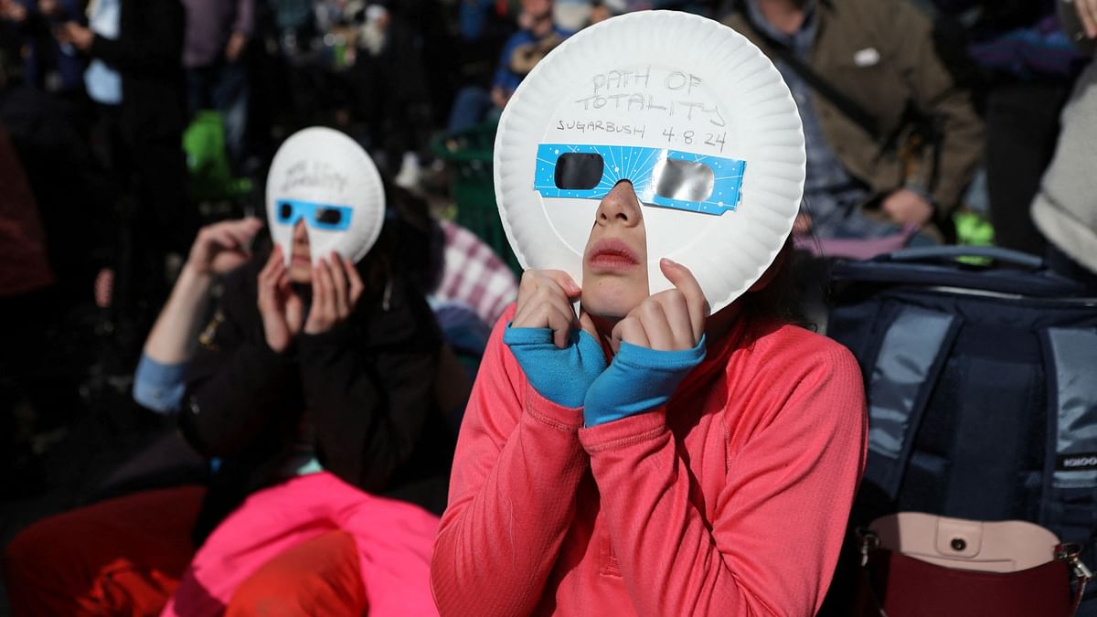 People hold on to their glasses eager to view the total solar eclipse in Vermont, US.