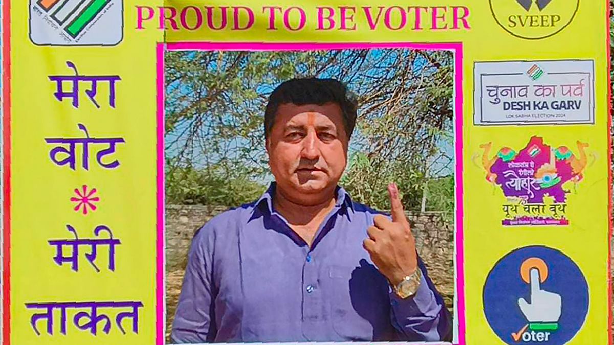 Rajasthan Minister of State KK Vishnoi shows his ink-marked finger while posing for a photo at a selfie point after casting his vote for the second phase of Lok Sabha elections, in Jodhpur.