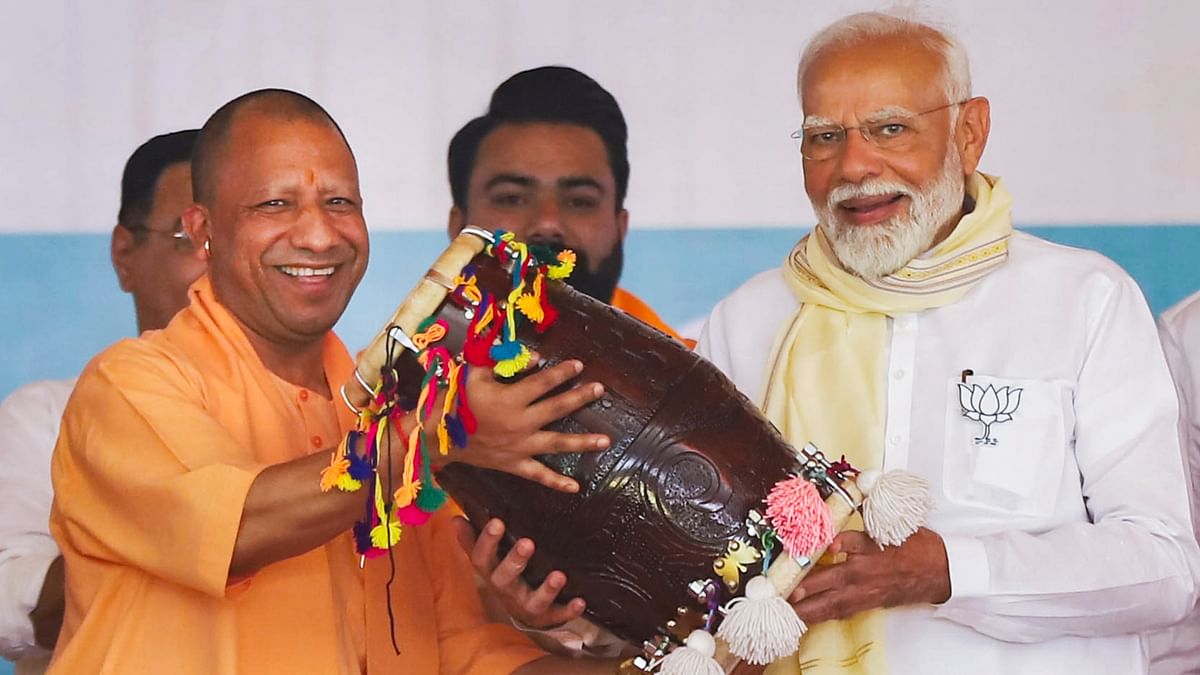 Prime Minister Narendra Modi being felicitated by Uttar Pradesh Chief Minister Yogi Adityanath during a public meeting for the Lok Sabha elections, at Gajraula in Amroha.
