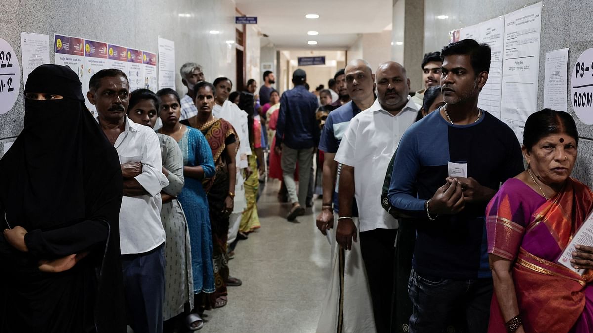 People line up to vote during the second phase of the general elections, in Bengaluru.