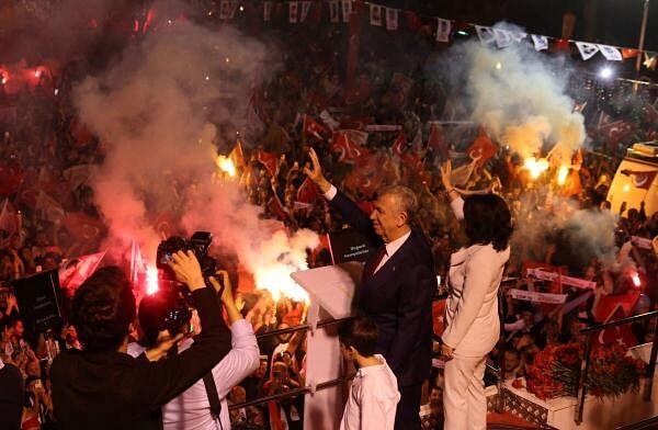 Ankara Mayor Mansur Yavas, mayoral candidate of the main opposition Republican People's Party (CHP), greets his supporters at the CHP headquarters following the early results during the local elections in Ankara.