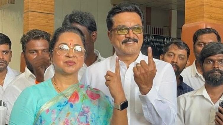 Celeb couple Radika and Sarathkumar show their ink-marked fingers after exercising their right  to vote, in Chennai.