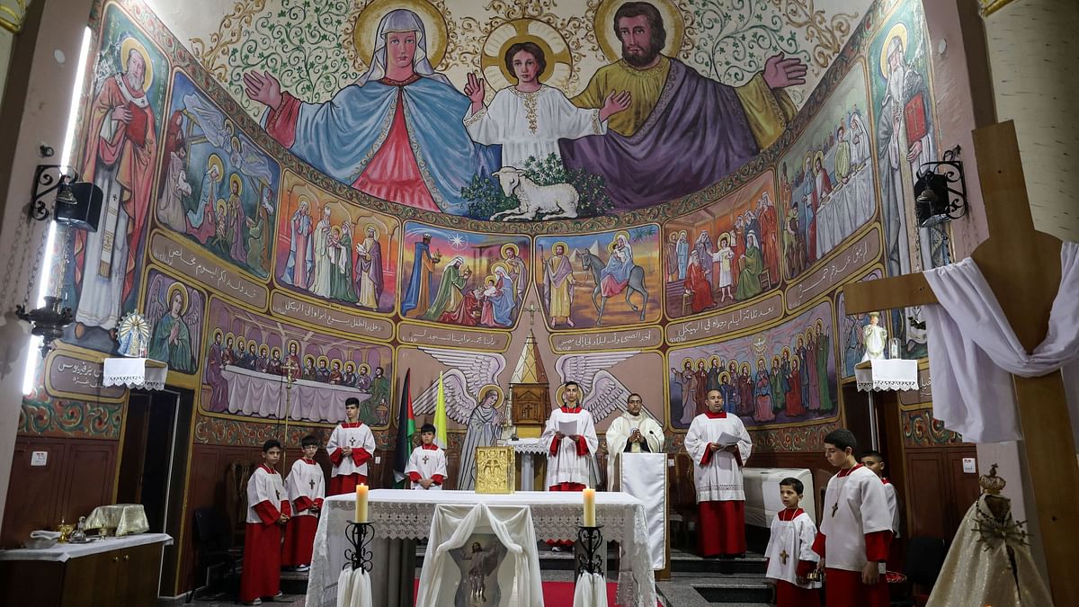 Palestinian Christians take part in an Easter mass at the Holy Family Church amid muted festivities, as the conflict between Israel and Hamas continues, in Gaza.