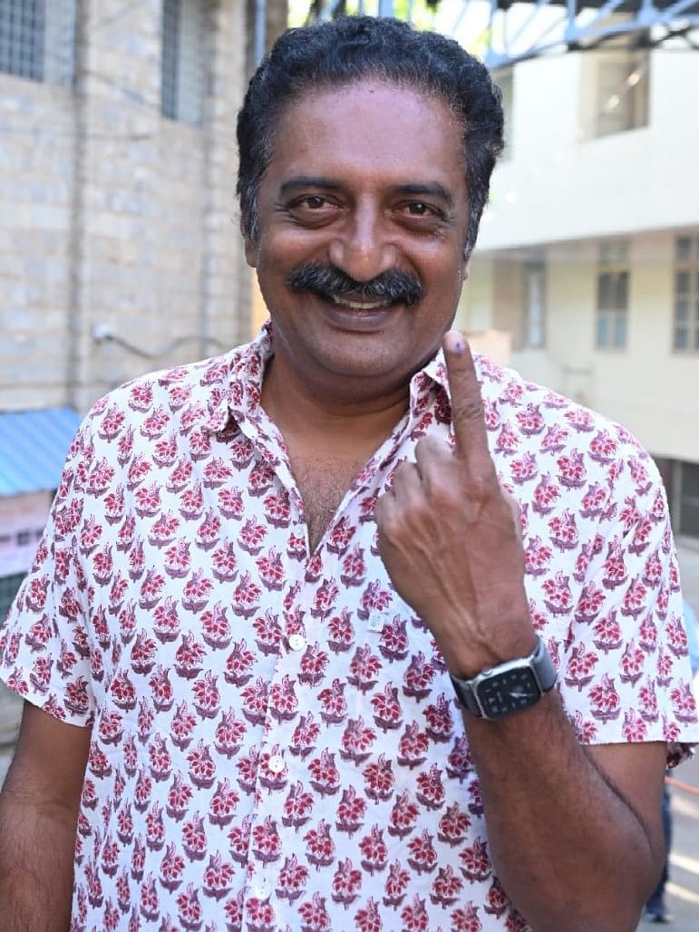 Actor and politician Prakash Raj shows his ink-marked finger after casting his vote at the St Joseph's Indian High School, Vittal Mallya Road. 