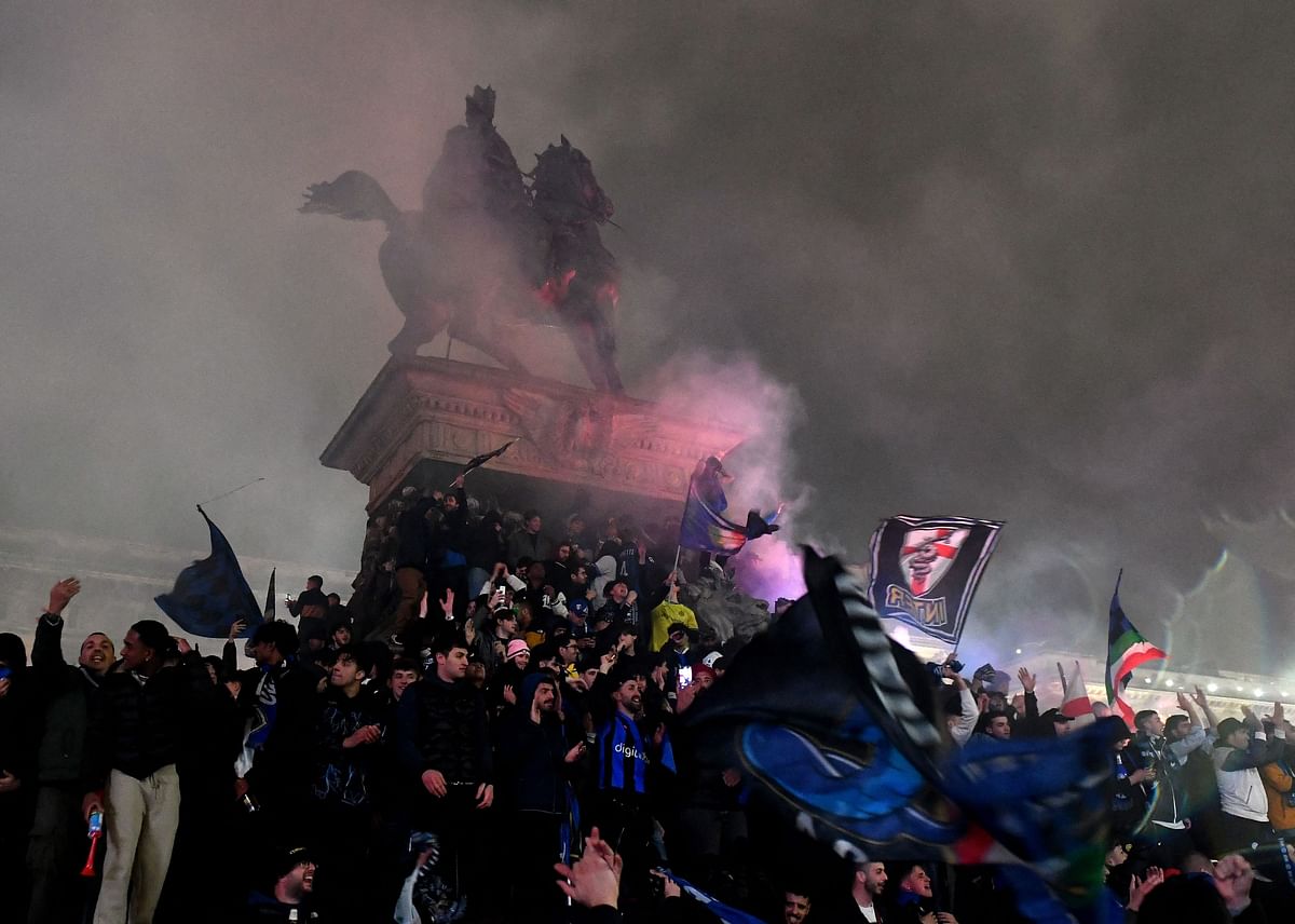 Ecstatic Inter Milan fans celebrate winning Serie A in Piazza del Duomo in Milan.