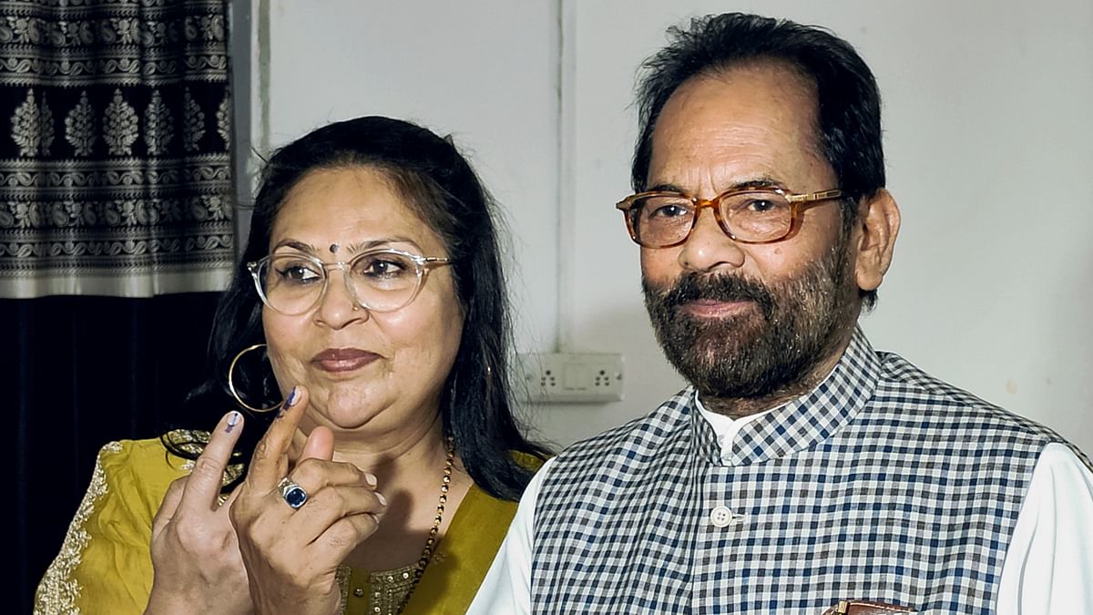 Senior BJP leader and former Union Cabinet Minister Mukhtar Abbas Naqvi and his wife show their fingers marked with indelible ink after casting their vote for the first phase of Lok Sabha elections, in Rampur.
