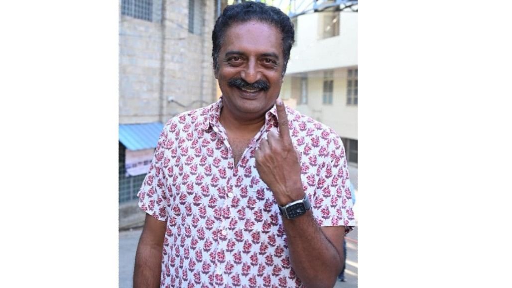Actor and politician Prakash Raj shows his ink marked finger after casting his vote at the St Joseph's Indian High School in Vittal Mallya Road,  Bengaluru.