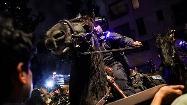 Police officers ride horses as people take part in a protest against Israeli Prime Minister Benjamin Netanyahu's government and demand the release of hostages kidnapped in the deadly attack on Israel by the Palestinian Islamist group Hamas on October 7, 2024 in Tel Aviv, Israel became .