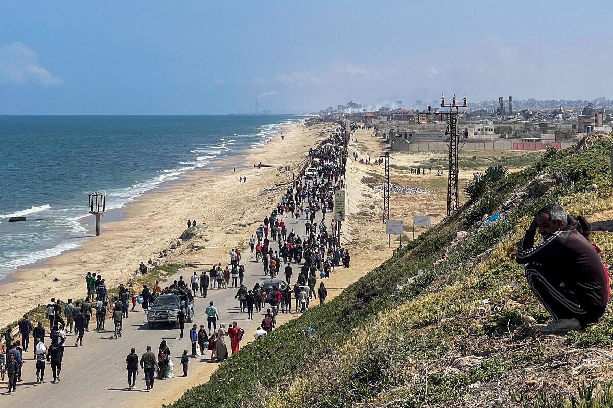 Palestinians, who were displaced by Israel's military offensive on south Gaza, make their way as they attempt to return to their homes in north Gaza, amid the ongoing conflict between Israel and Hamas, as seen from central Gaza Strip April 14, 2024.
