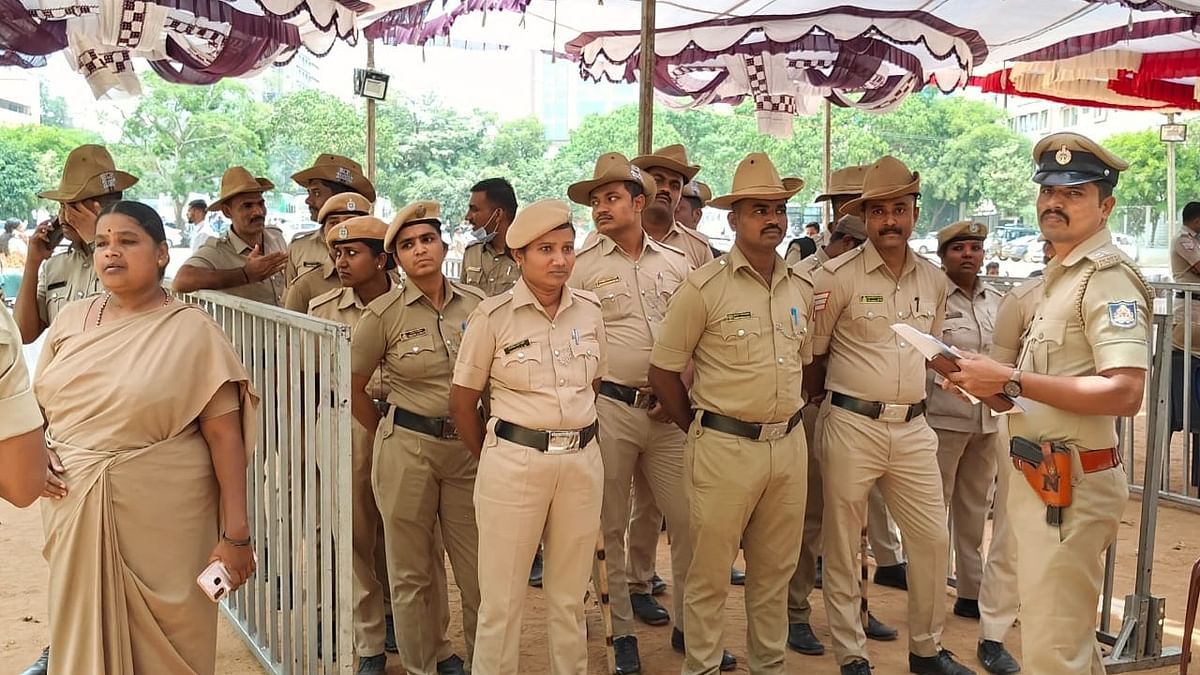 Police officials arrive at a polling station ahead of the second  phase of Lok Sabha elections, at St Joseph's School in Bengaluru.