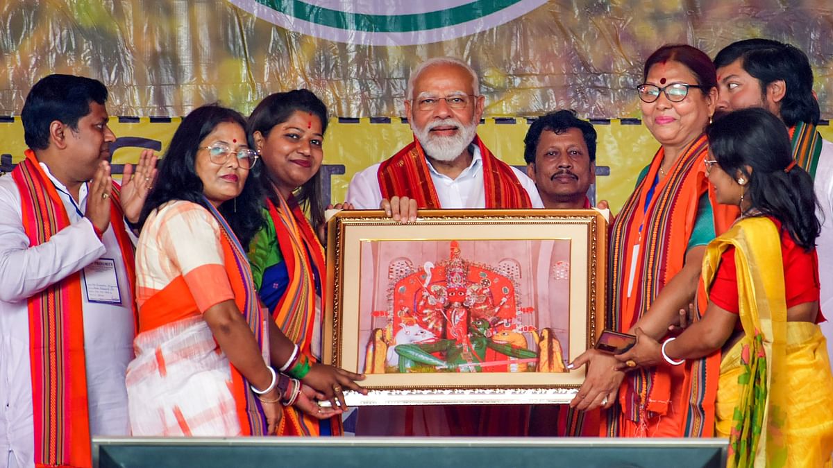 PM Modi poses with the supporters during rally in support of NDA candidates ahead of Lok Sabha elections, in Cooch Behar.