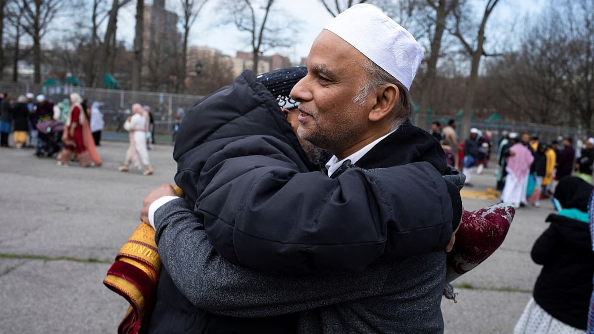 Muslim men greet each other for Eid al-Fitr, marking the end of the holy month of Ramadan, at Van Cortlandt Park in the Bronx borough of New York City.