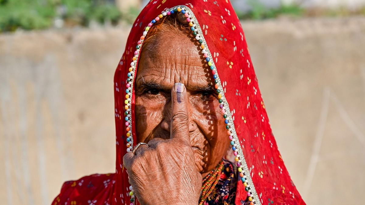 A woman shows her ink-marked finger after casting her vote for the second phase of Lok Sabha elections, in Ajmer, Rajasthan.