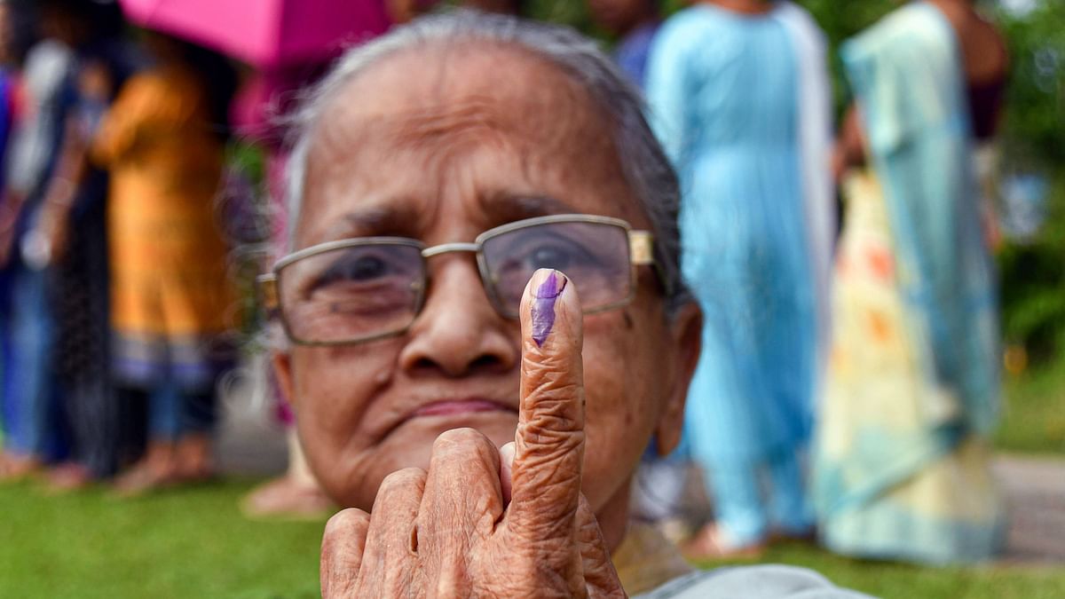 An elderly voter shows her ink-marked finger after casting her vote for the second phase of Lok Sabha elections, at Dharmanagar in Tripura.