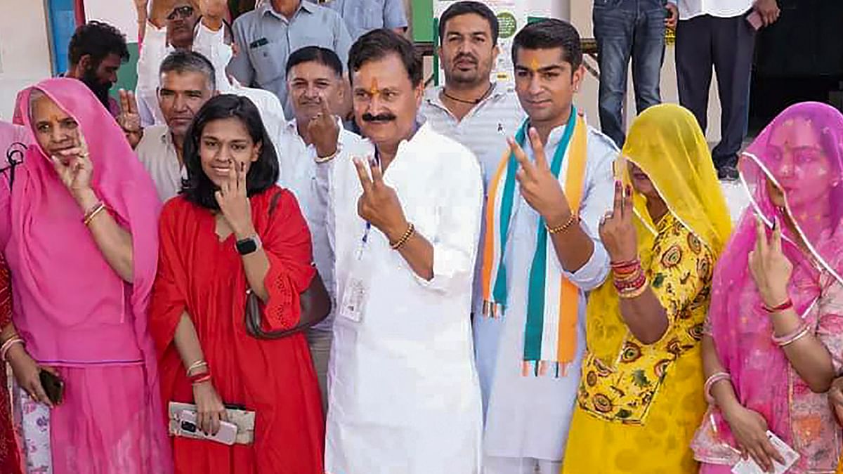 Congress candidate from Jodhpur constituency Karan Singh Uchiyarda and his family members show victory sign after casting their vote for the second phase of Lok Sabha elections, in Jodhpur.