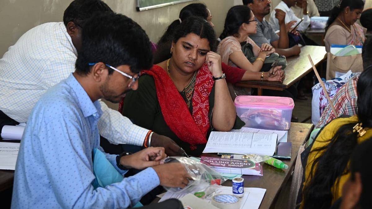 Polling agents check the election materials ahead of the second phase of the general elections, in Bengaluru.