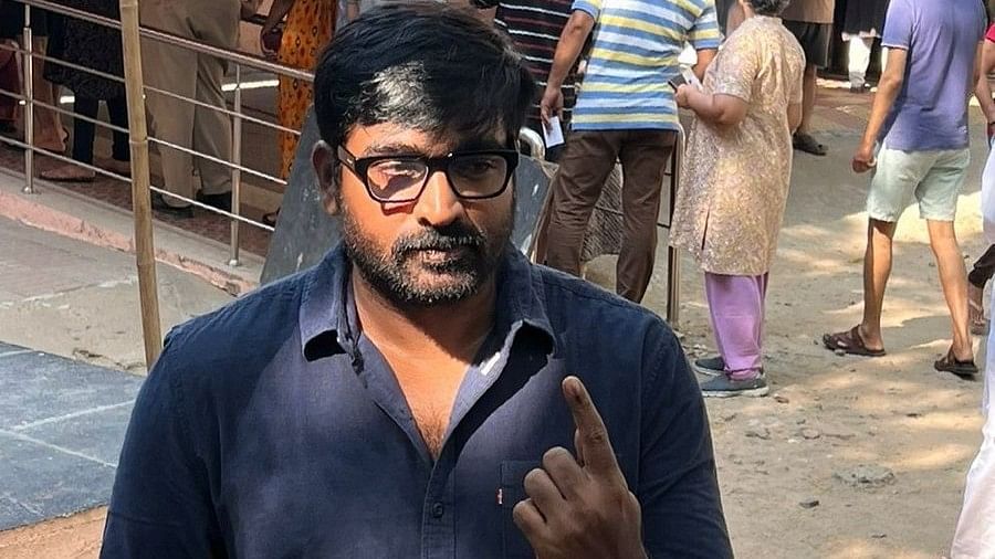 Actor Vijay Sethupathi poses for the media as he leaves after casting his vote in the first phase of Lok Sabha elections, at a polling station in Chennai.