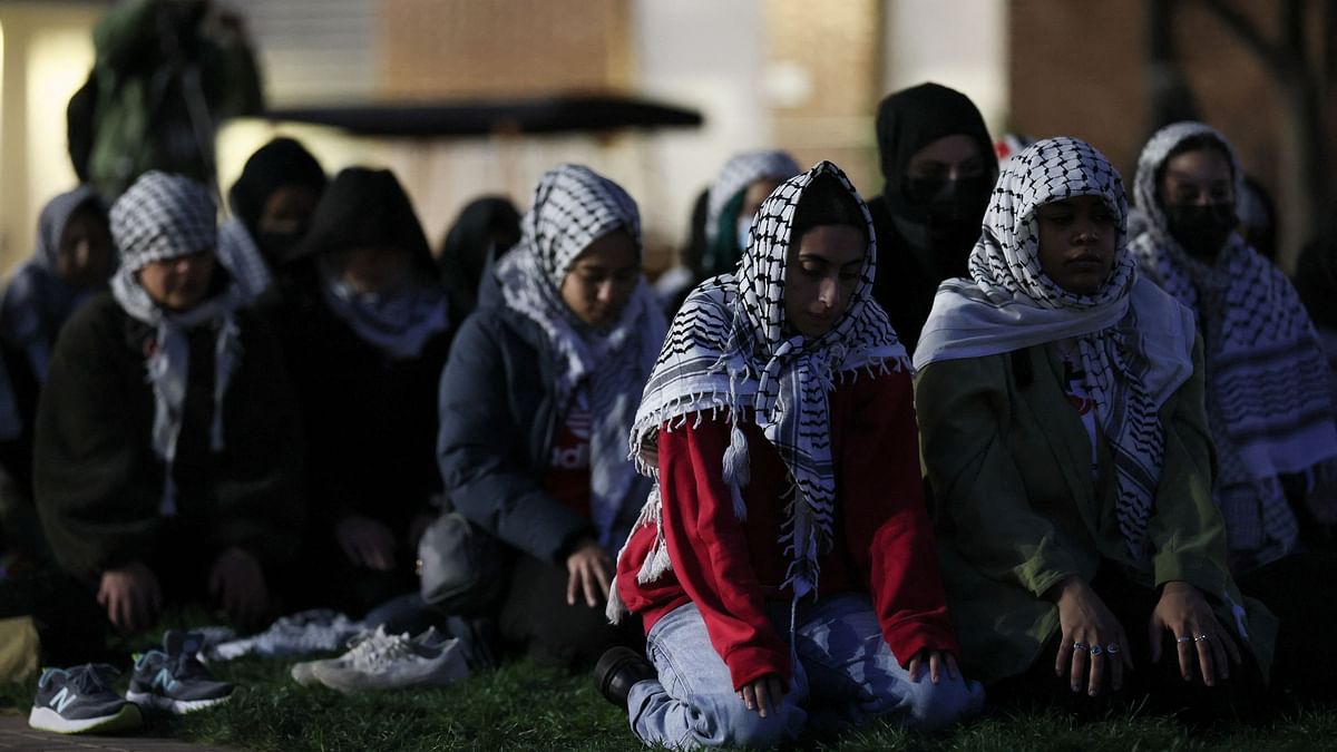 People pray as students and others demonstrate at a protest encampment at University Yard in support of Palestinians in Gaza, during the ongoing conflict between Israel and the Palestinian Islamist group Hamas, at George Washington University in Washington, U.S., April 25, 2024. 