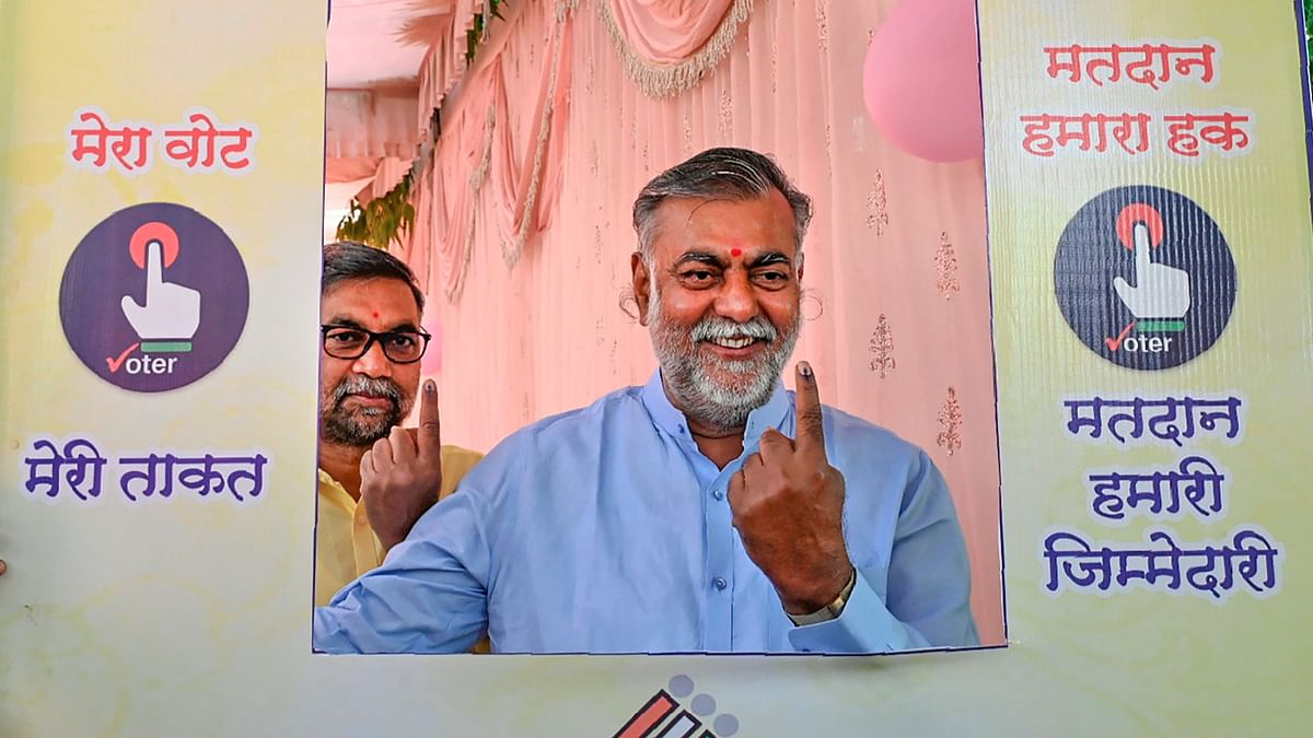 Madhya Pradesh minister and BJP leader Prahlad Patel shows his inked finger at a selfie stand after casting his vote in the second phase of Lok Sabha elections, in Narsinghpur.