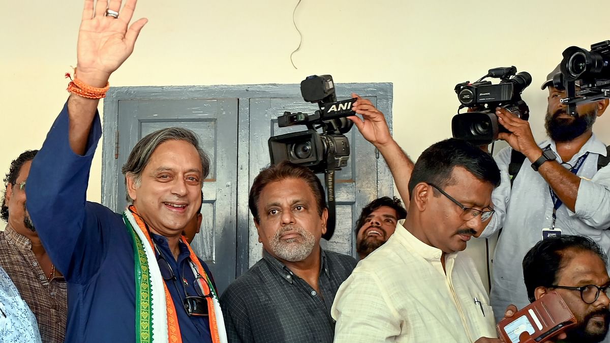 Congress candidate Shashi Tharoor waves while standing in a queue to cast his vote for the second phase of Lok Sabha elections, in Thiruvananthapuram.