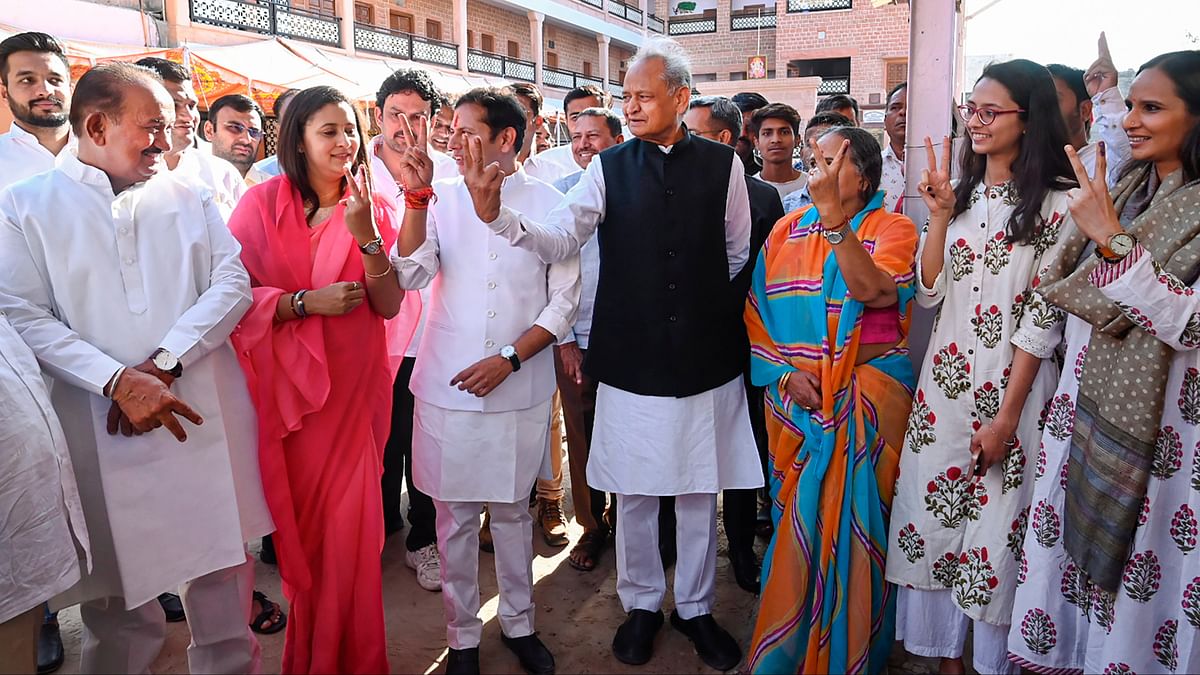 Former Rajasthan chief minister Ashok Gehlot shows victory sign as he arrives to cast his vote in the second phase of Lok Sabha elections, in Jodhpur.