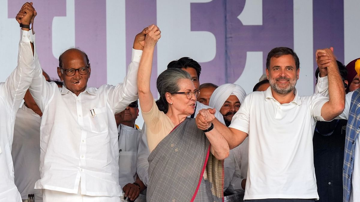 NCP chief Sharad Pawar joins hands with Congress leaders Sonia Gandhi and Rahul Gandhi during I.N.D.I.A. bloc's 'Loktantra Bachao Rally' at Ramlila Maidan, in New Delhi.