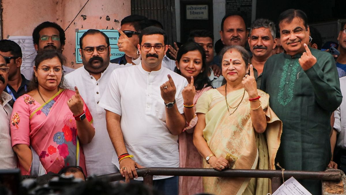 BJP candidate from Nagpur Nitin Gadkari with his family shows his finger marked with indelible ink after casting his vote for the first phase of Lok Sabha elections, in Nagpur.