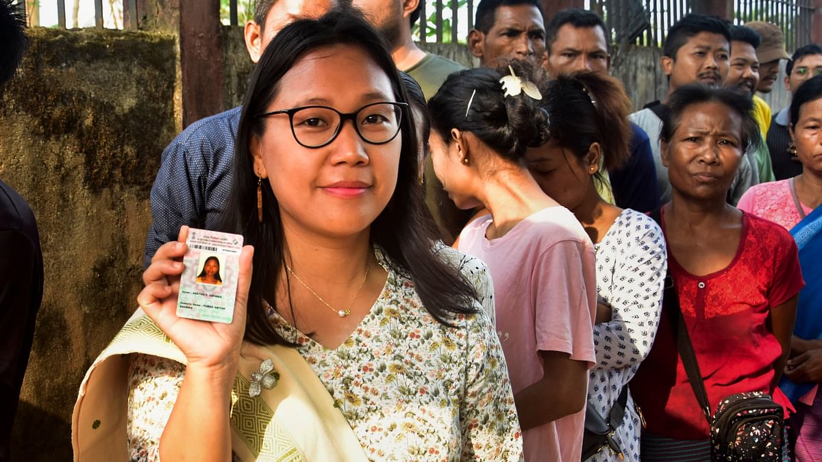 NPP candidate Agatha Sangma shows her identification card as she waits in a queue at a polling station to cast her vote for the first phase of Lok Sabha elections, in Tura, Meghalaya.