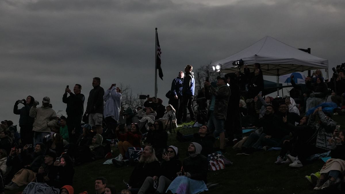 People assemble to view a total solar eclipse at Niagara Falls, New York.