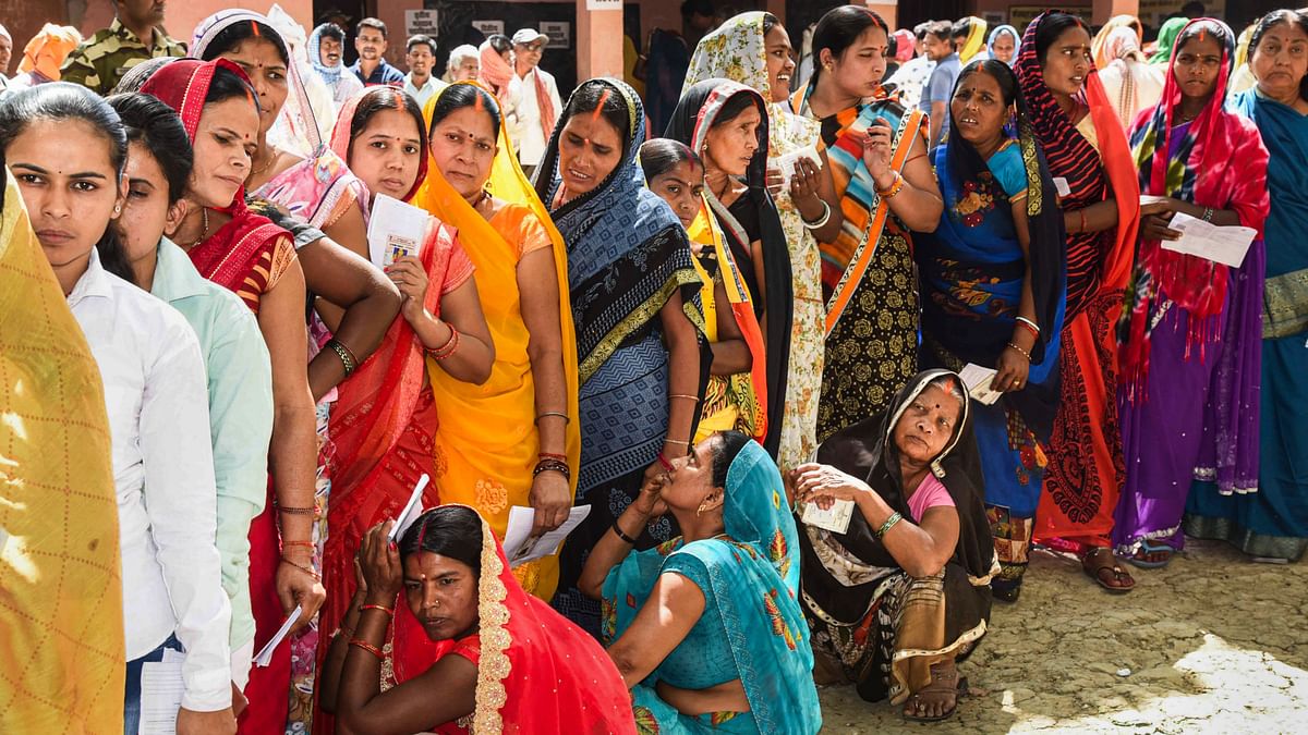 Voters wait to cast their votes for Lok Sabha elections, in Aurangabad, Bihar.