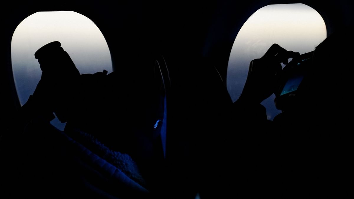 Passengers sit in a special Delta Airlines eclipse flight as it moves over the skies of the US.