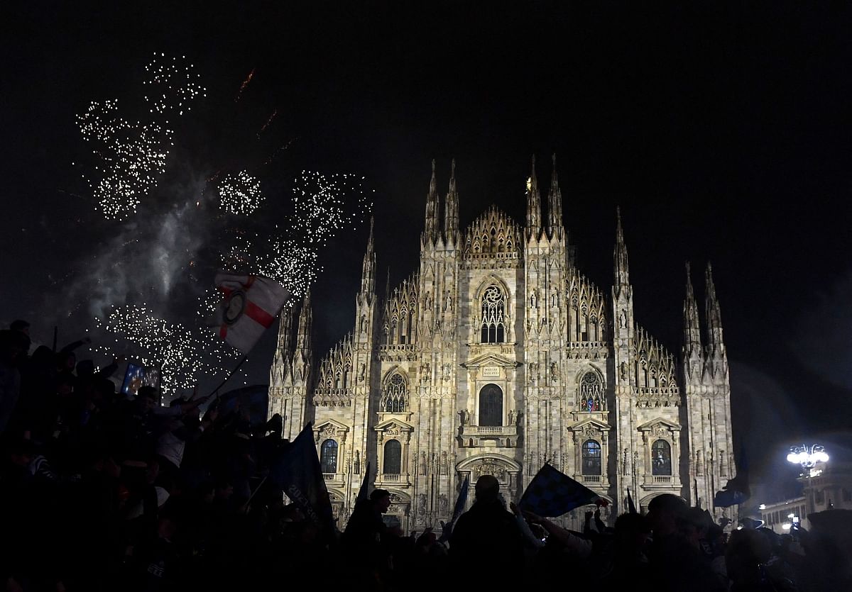 Fireworks light up the night sky above Piazza del Duomo in Milan amid celebrations by Inter fans.
