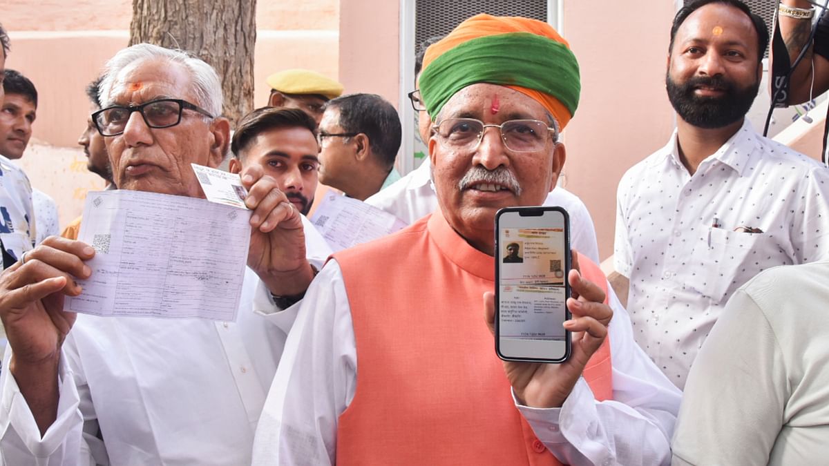 Union Minister Arjun Ram Meghwal shows his identification card as he arrives to cast his vote for the first phase of Lok Sabha elections, in Bikaner.