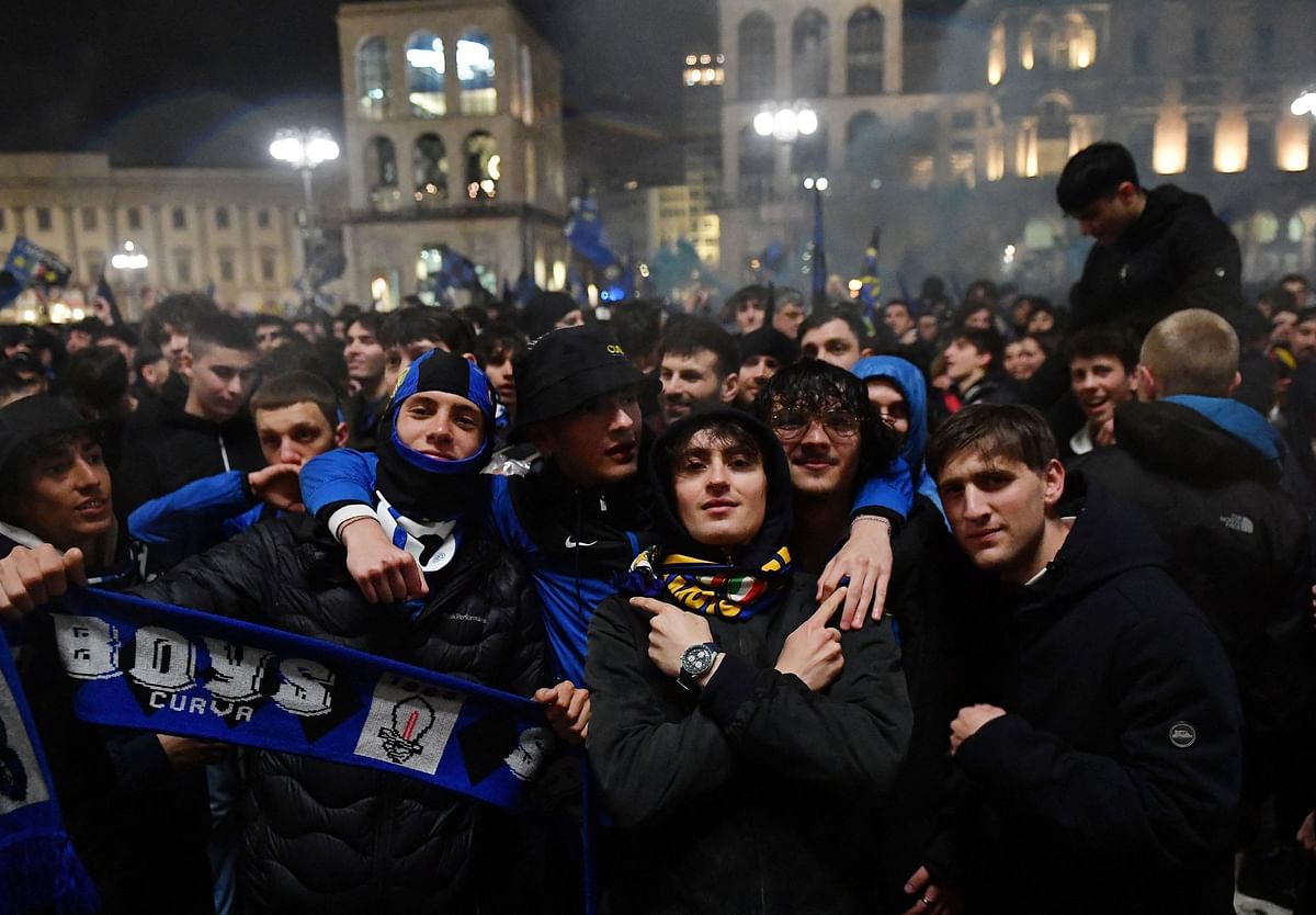 Inter Milan fans pose for a photo amid wild celebrations in Milan.