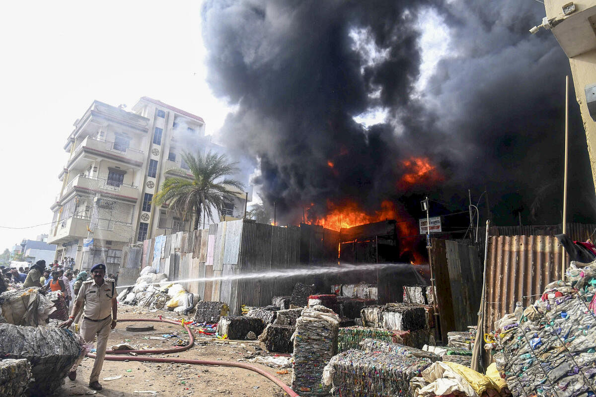 Firefighters douse a fire breaking out of a scrap warehouse, in Patna, Saturday, April 6, 2024.