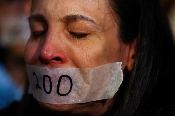 A woman with her mouth sealed reacts during a protest to mark 200 days since the start of the conflict between Israel and the Palestinian Islamist group Hamas, in Tel Aviv, Israel April 23, 2024.