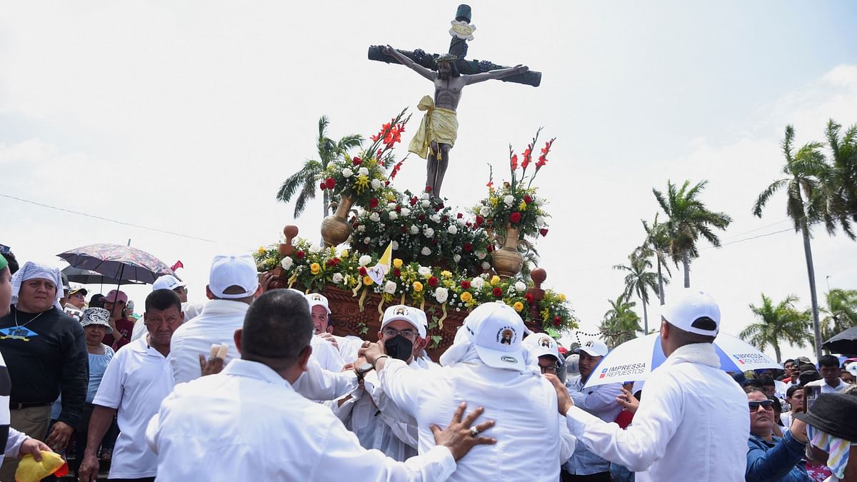 People take part in a Good Friday procession in the courtyards of the Metropolitan Cathedral, in Managua, Nicaragua.
